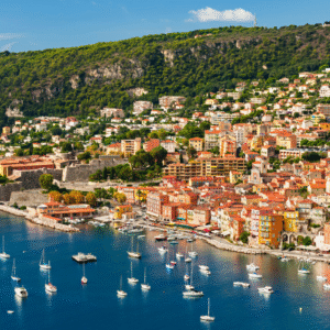 Colourful hillside buildings and sailboats in the harbour at Villefranche-sur-Mer, French Riviera